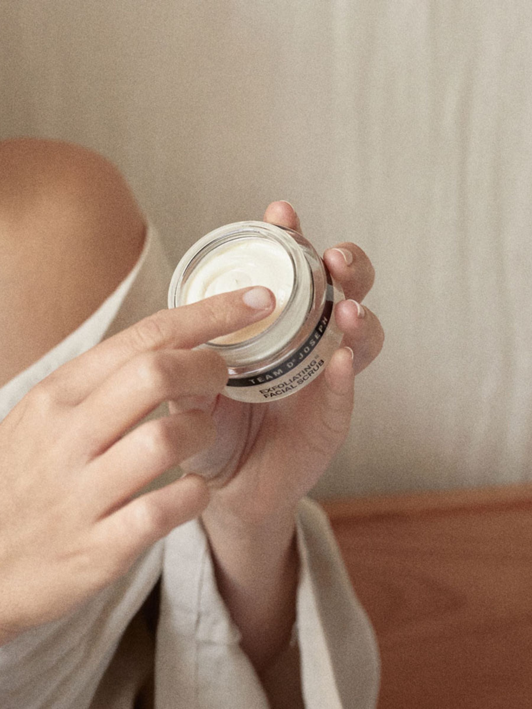 Exfoliating facial scrub by TEAM DR JOSEPH in a 50 ml tube, showing the creamy texture and natural ingredients.